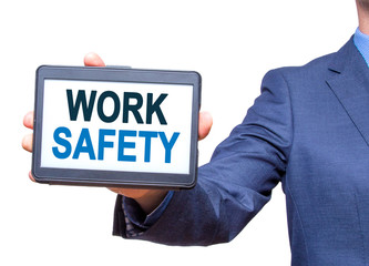 Businessman hand holding tablet with WORK SAFETY text sign. Isolated on white. Business concept. Stock photo