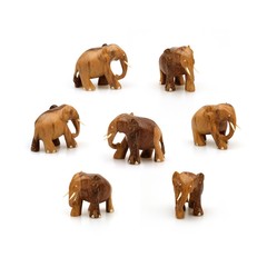 Wooden souvenir elephant made of wood and ivory on a white background