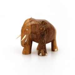 Wooden souvenir elephant made of wood and ivory on a white background