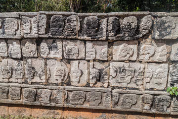 Carveed skulls at the Platform of Sculls at the archeological site Chichen Itza, Mexico