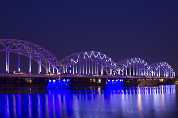 Railroad bridge over river Daugava in Riga at night