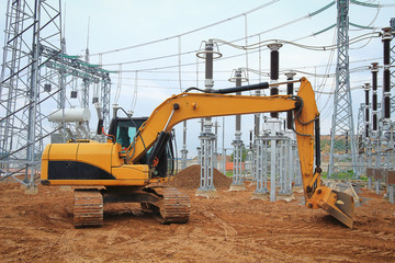 Crawler excavator at construction site of electrical substation of industrial sector
