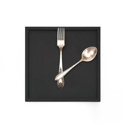 Crossed fork and spoon on a black tray