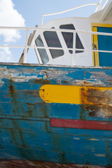 Fototapeta na wymiar Jacked up colourful fishing boat 