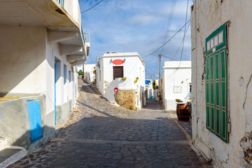 Obraz na płótnie Canvas Street with historic white houses in village of Tripiti on Milos island. Cyclades, Greece.