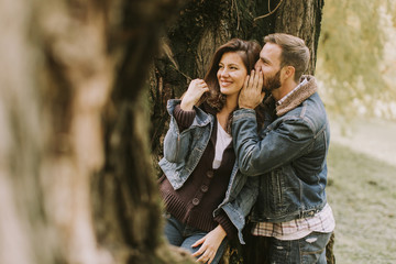 Smiling couple hugging in autumn park