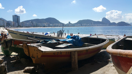 Fototapeta na wymiar Copacabana, Rio de Janeiro, Brazil - June 25, 2017 - View of Copacabana beach and the traditional fisherman's colony boats on typical Rio summer day
