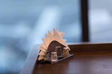 blurred background of window on airport and board. the napkins in the napkin holder