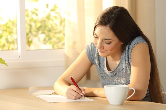 Girl writing a letter on a table