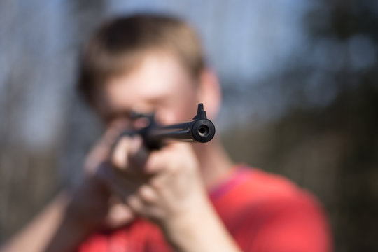 man with air gun in forest