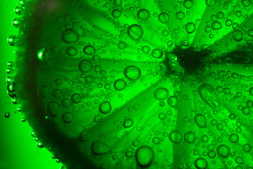 lime with bubbles on green background