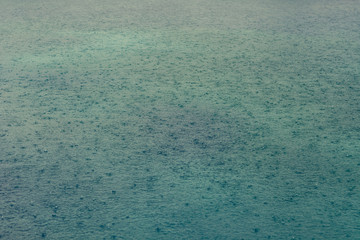 Rain drops on lake surface.