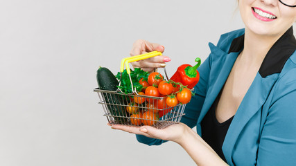 Obraz na płótnie Canvas Woman holds shopping basket with vegetables