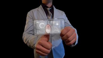 Man with a futuristic screen.  The concept of the future interface on a transparent display