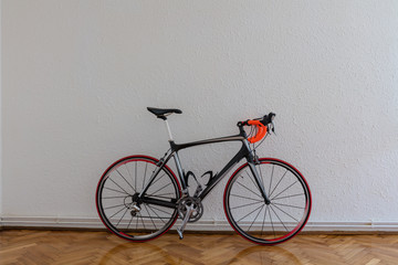 Obraz na płótnie Canvas Race bike next to white wall