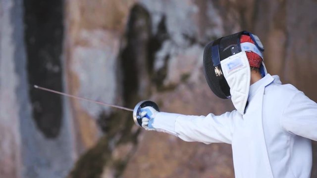 Pointing fencing sword to left part of frame