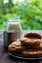 Delicious homemade cookies and jug of milk on table. Home food, vertical photo