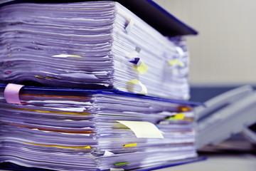 Many paper files on the desk