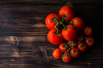 Fototapeta na wymiar Fresh tomatoes on vintage wooden table