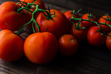 Fototapeta na wymiar Fresh tomatoes on vintage wooden table