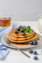 Stack of pancakes with fresh blueberry and caramel syrup