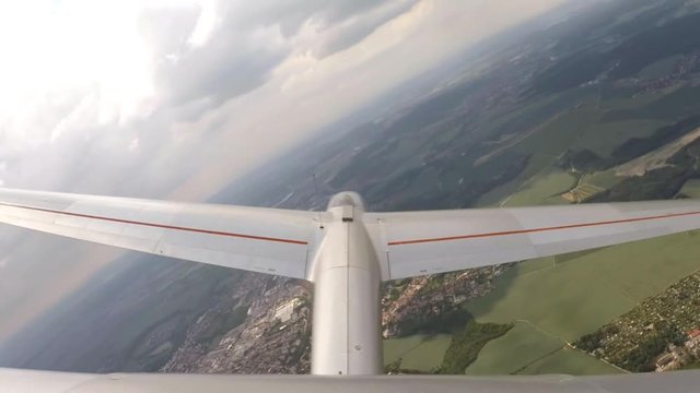 Glider flight over urban landscape around Pilsen in Czech Republic, Central Europe. Footage from action camera placed on aircraft elevator. Soaring under clouds. 