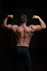 Obraz na płótnie Canvas Model Posing Biceps After Exercises