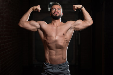 Fototapeta na wymiar Model Posing Biceps After Exercises