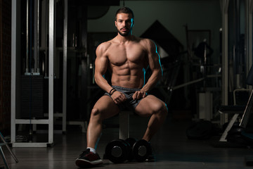 Fototapeta na wymiar Athlete Resting In Gym Afther Exercise