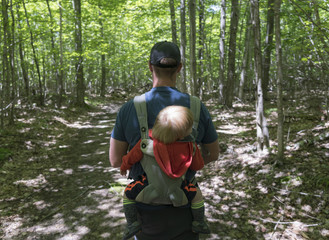 Man hiking with baby on back