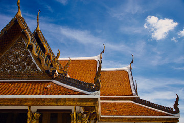 Fototapeta na wymiar Thailand, Bangkok temple roof against blue sky, Royal Pavilion Mahajetsadabadin