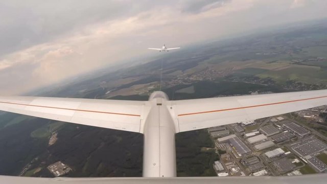 Aerotowing glider start and flight over urban landscape around Pilsen in Czech Republic, Central Europe. Footage from action camera placed on aircraft elevator. Soaring under clouds. 