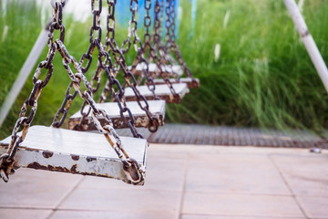 old wood swing in playground park