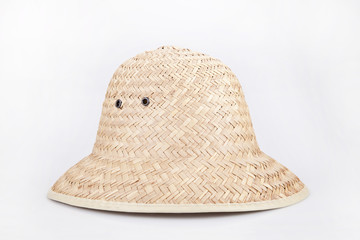 Straw hat on a white surface. Wicker hat isolated on white background.