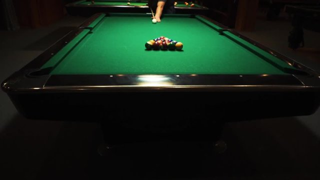 Playing billiards, blowing a cue on the ball, the ball hit the pocket, the ball did not hit the pocket, misfire, hit, American billard, pool, green billiard table, the man plays billiards, breaking