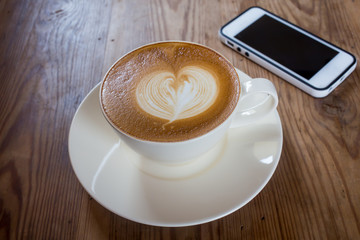 Coffee cup with milk on the table