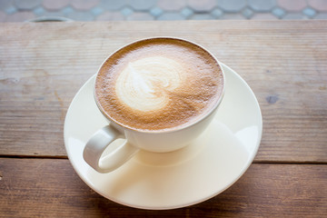 Coffee cup with milk on the table
