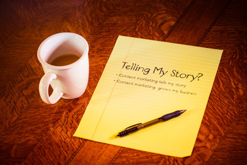 yellow legal paper with pen and coffee