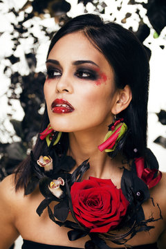 pretty brunette woman with rose jewelry, black and red, bright m