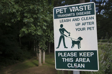 Pet waste sign reminding owner to clean up after their pets