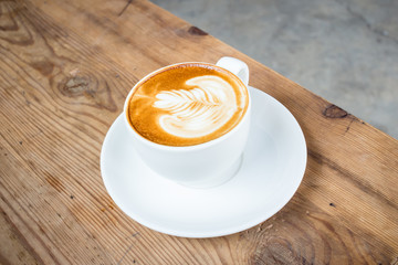 Coffee latte art on wood table