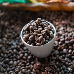 white cup with coffee beans
