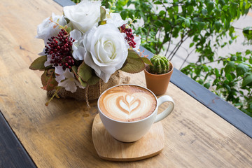 Cup of coffee on a table with flowers