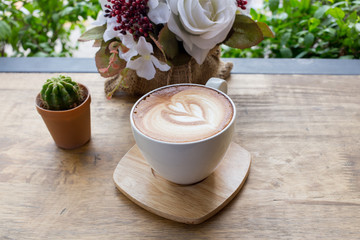 Cup of coffee on a table with flowers