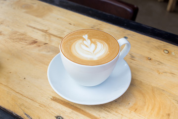 Coffee latte art on wood table