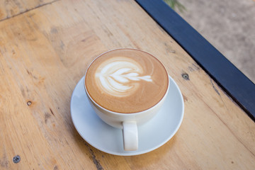 Coffee cup with milk on the table