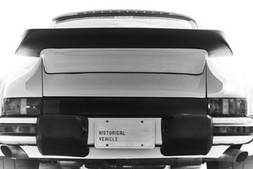 Rear of wide body of retired antique German racing car with black spoiler