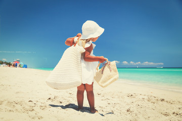 lets go to beach -little girl with bags at sea
