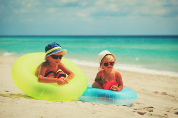 cute little boy and girl play on beach