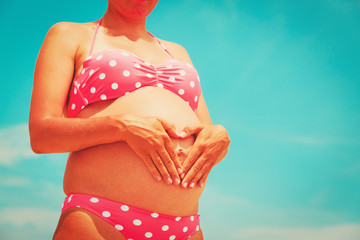 Fototapeta premium Pregnant woman at sand beach